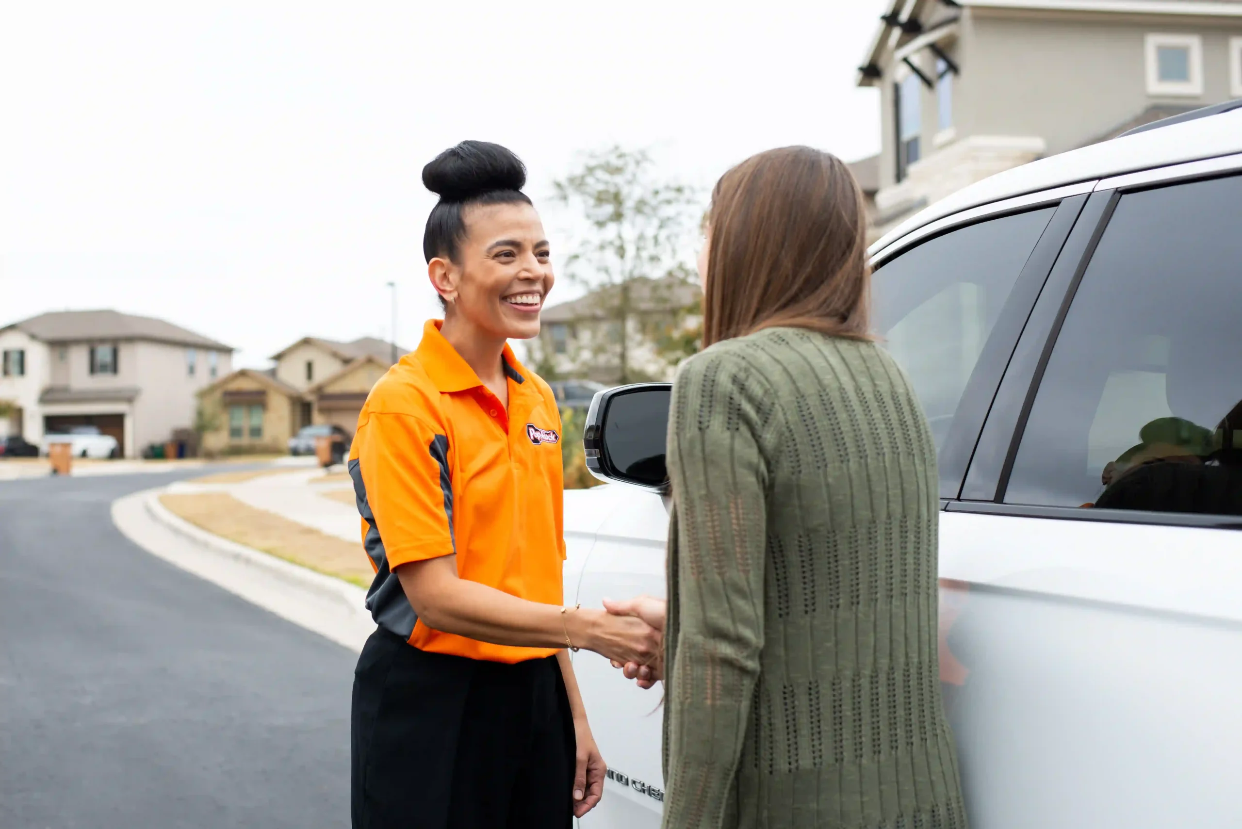 Pop-A-Lock locksmith shaking hands with a customer
